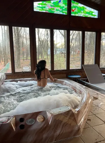 Indoor hot tub with jungle views